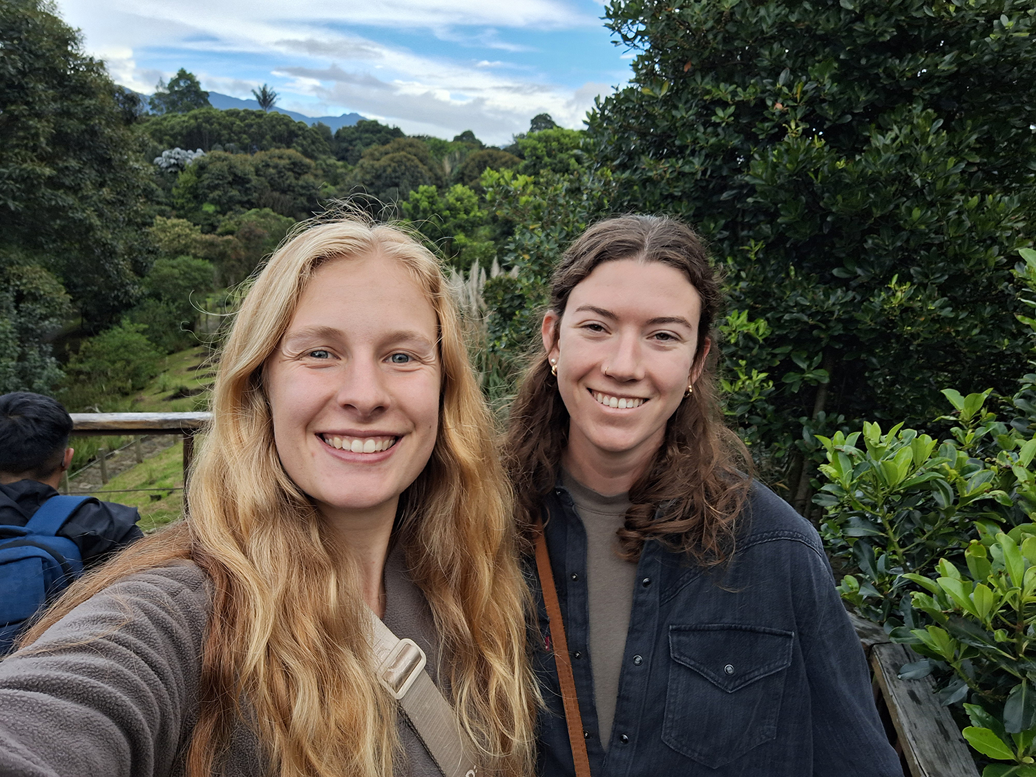 Two people posing outside.