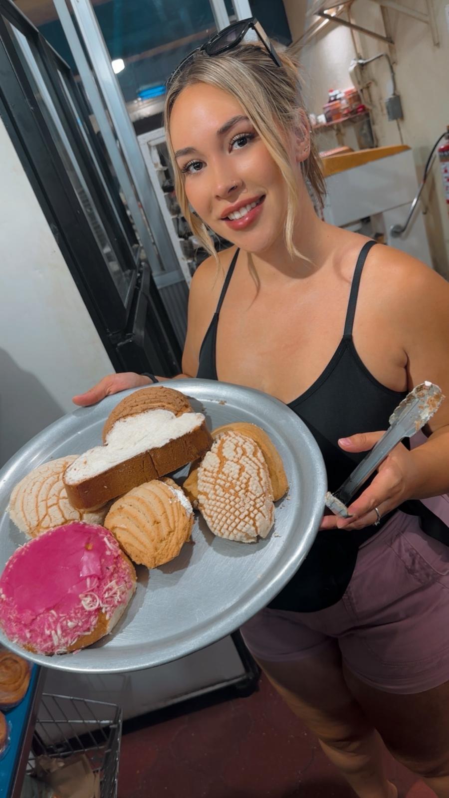 Jasmine holding a plate of pastries.