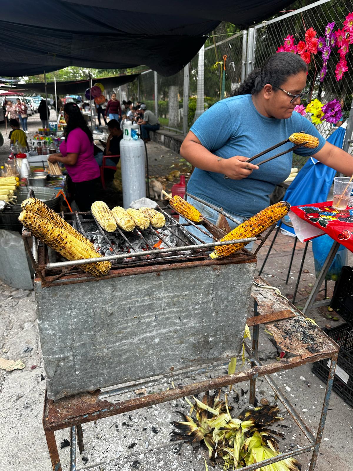 Corn roasting in an outdoor market.