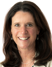 Headshot of a smiling middle-aged woman with dark hair against white background