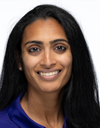Smiling headshot of a woman with long dark hair wearing a blue top.