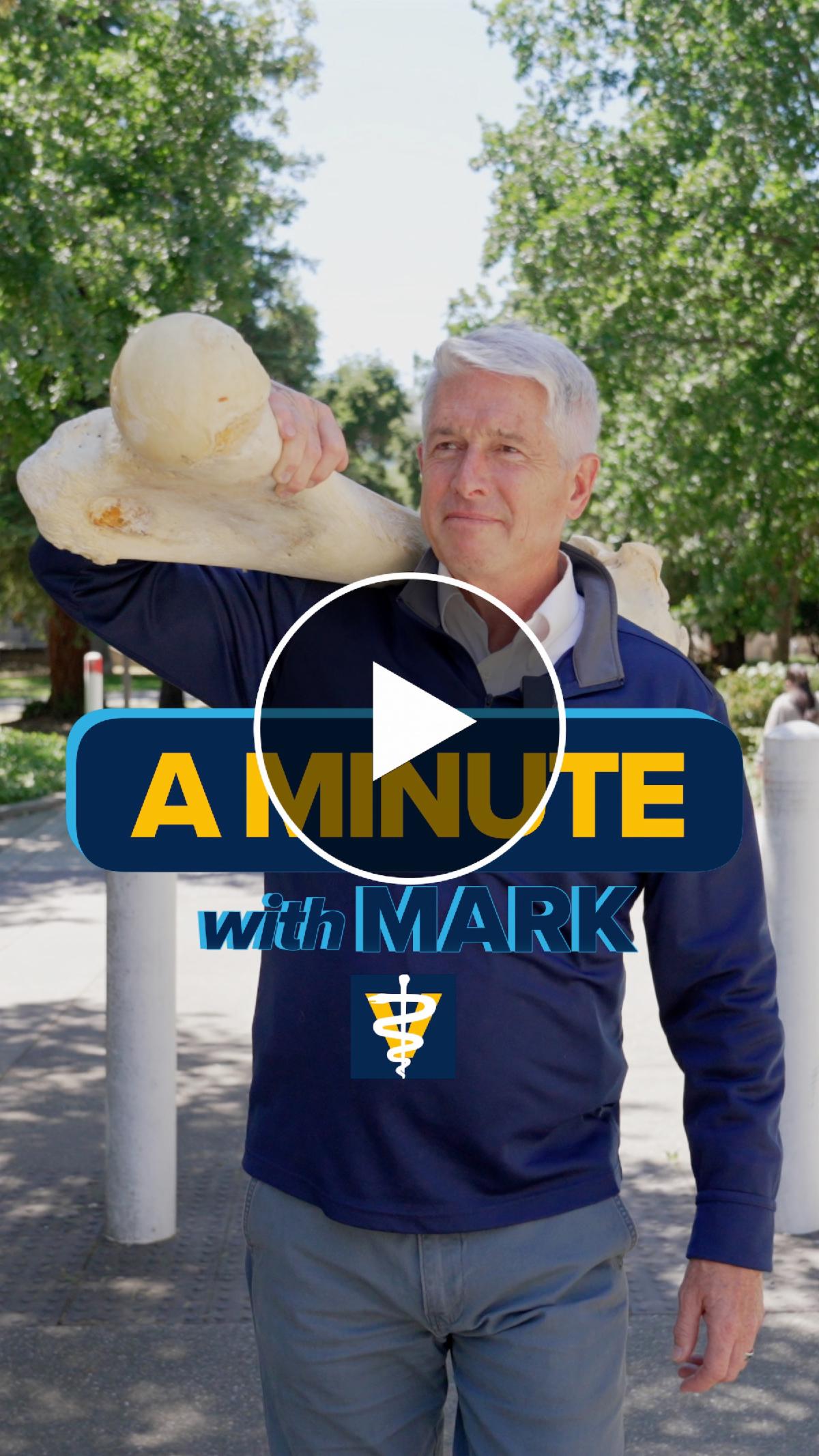 Cover of a Minute with Mark video short showing Dean Stetter carrying very large bone over his shoulder.