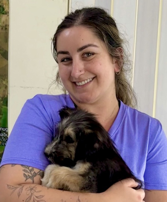 Saya Nei holding a puppy.