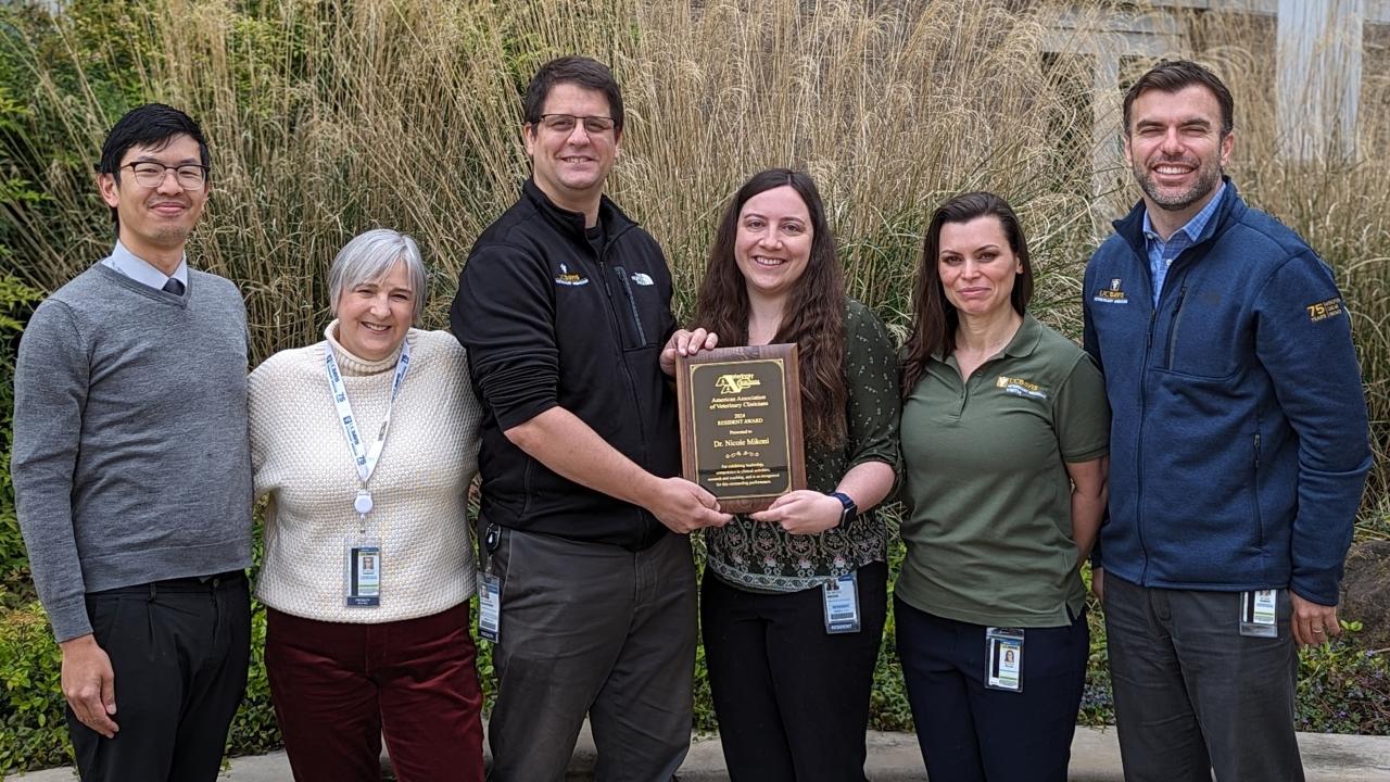 group of veterinarians presenting an award