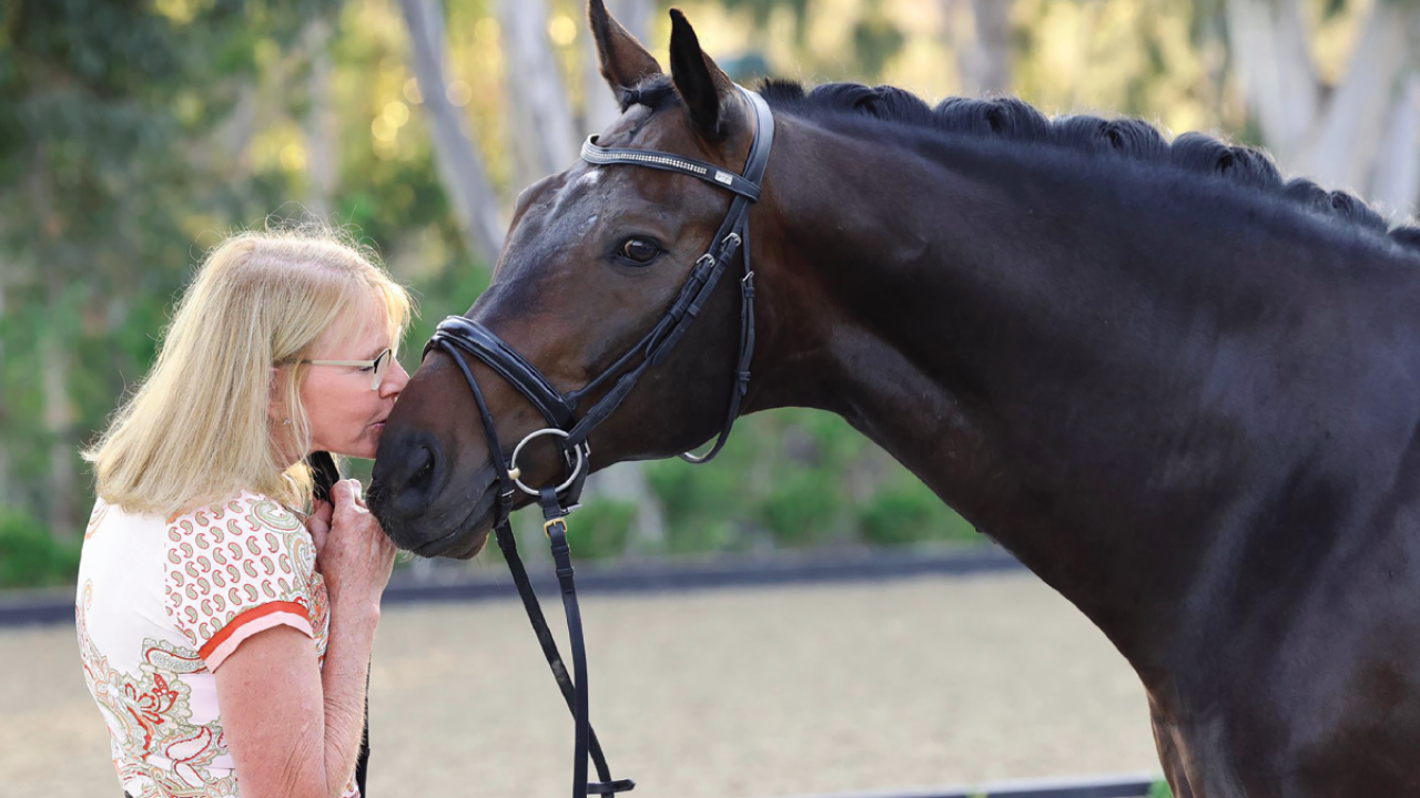 woman kissing horse
