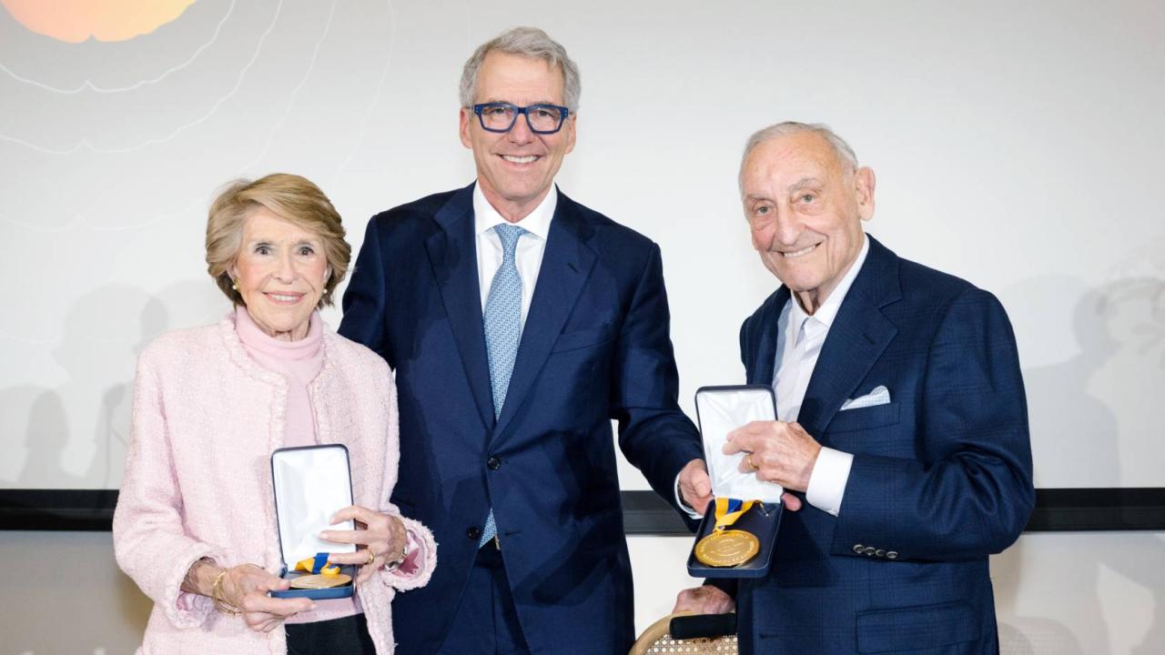 Joan Weill, left, stands next to President Milliken, who is next to Sanford I. Weill, both Weills holding their gold medals.