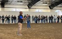 two veterinarians talking with group of students