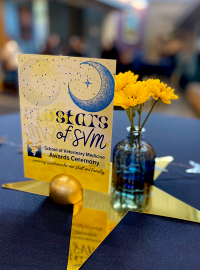 Tabletent on a gold star with flowers at the 2024 awards ceremony reception.