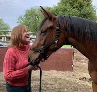 woman smiling at horse