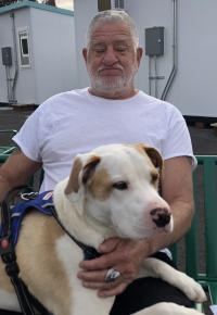man and dog on bench