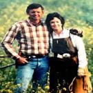 Two people standing and smiling