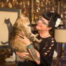 Kate Benjamin in 2013 with one of her many cats, who are now helping her through her cancer treatment.