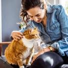 woman sitting on couch with cat